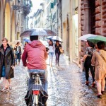 Cyclist umbrella Florence Italy